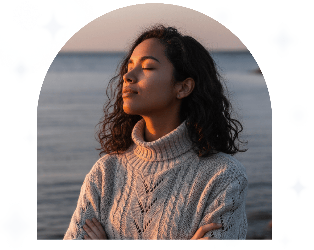 A young woman practices guided meditation in the living room on her sofa
